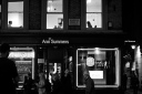 Three people working in an office above an Ann Summers shop in Soho
